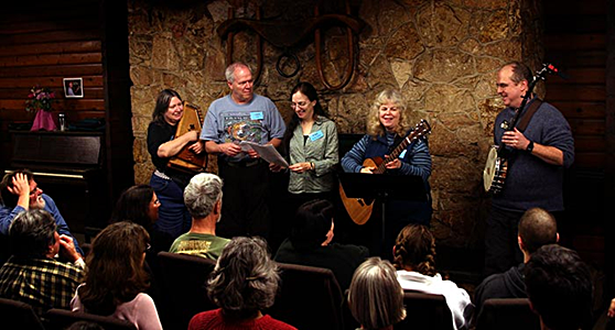 At Puget Sound Guitar Workshop, singing “We Are the Rainbow Sign” with friends including Tom Rawson, Meryle Korn, Hank Payne and Ellen Van der Heuven.