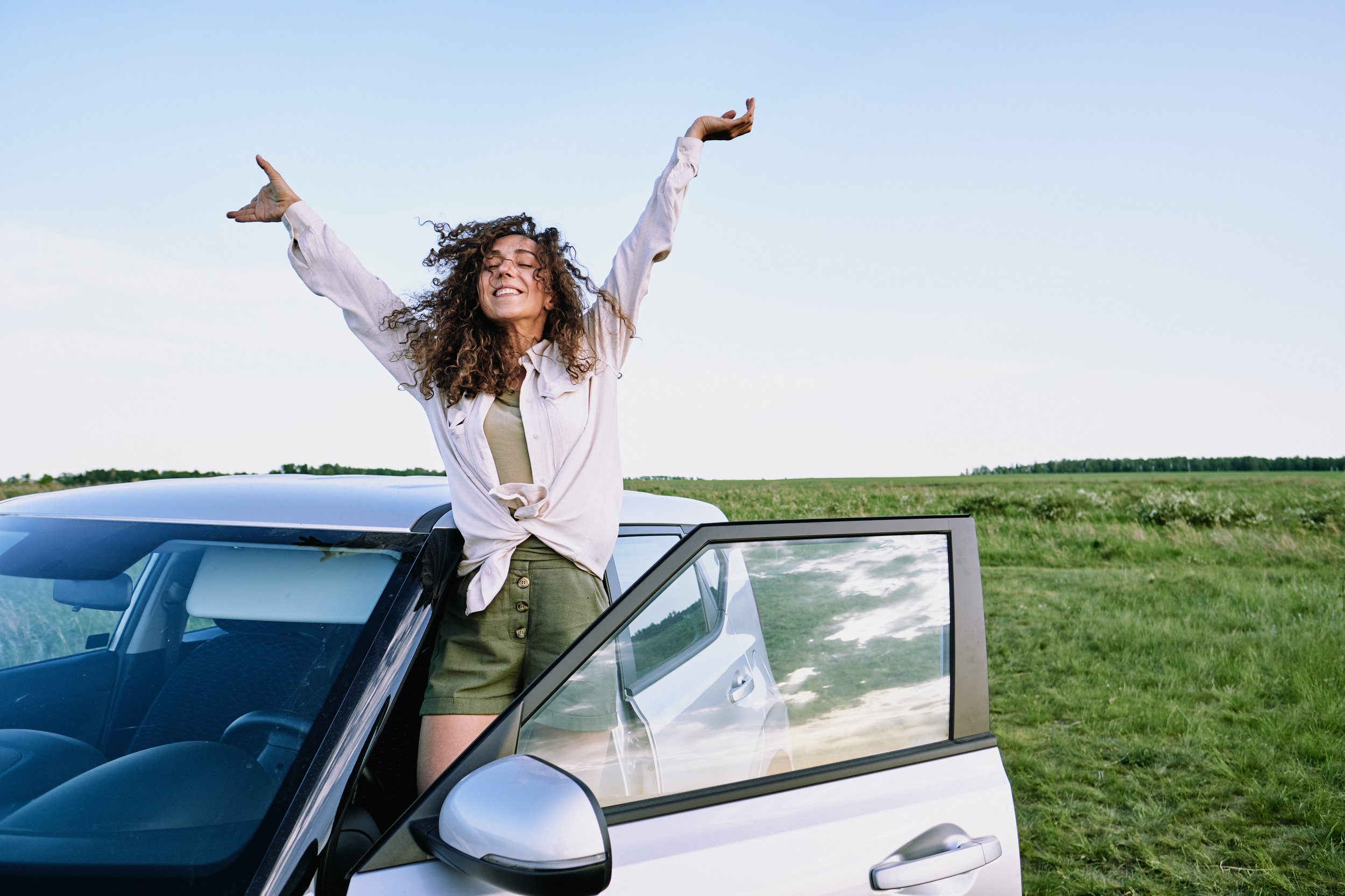 ecstatic-girl-having-fun-during-car-trip-DX5UMX4.jpg