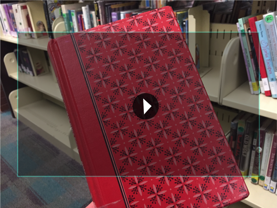 In this iteration, the user looks at the cover and triggers a short clip or trailer of the book.