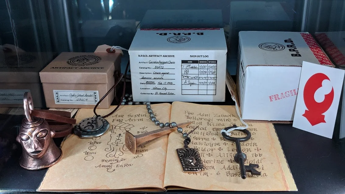 Mohlomi’s Bell, Agrippa’s Charm, Bog Roosh’s Nail, Ogdru Jahad Amulet, St Dunstans Key, and Lobster Johnson Calling Card by Skelton Crew Studios. Rasputin’s Journal by Mike Mignola from the Hellboy Deluxe DVD