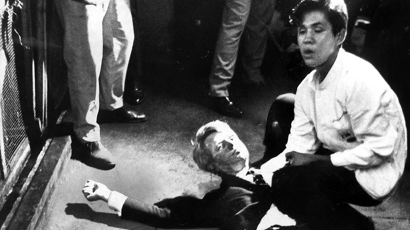 A mortally wounded senator Robert F. Kennedy is aided by Ambassador hotel busboy Juan Romero, age 17. Romero died in October, 2018.