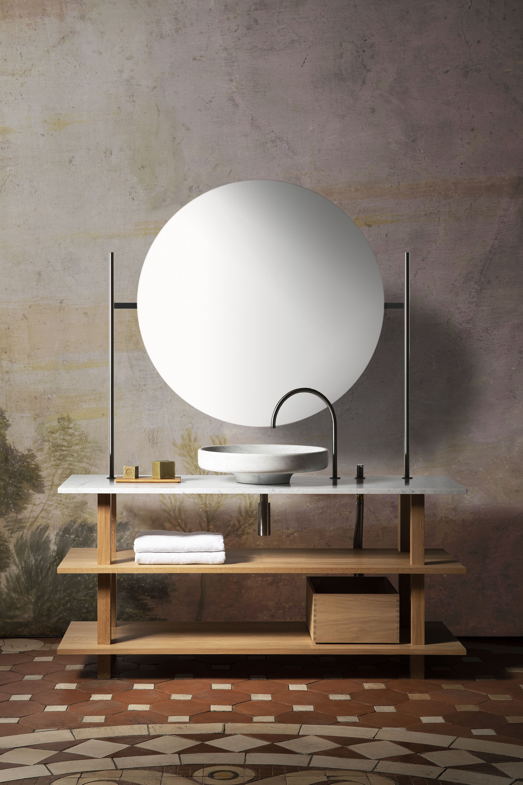 Open basin furniture in solid oak oiled for the bathroom with large round washbasin in white Carrara marble, solid stainless steel fittings and illuminating gantry with very large round mirror
