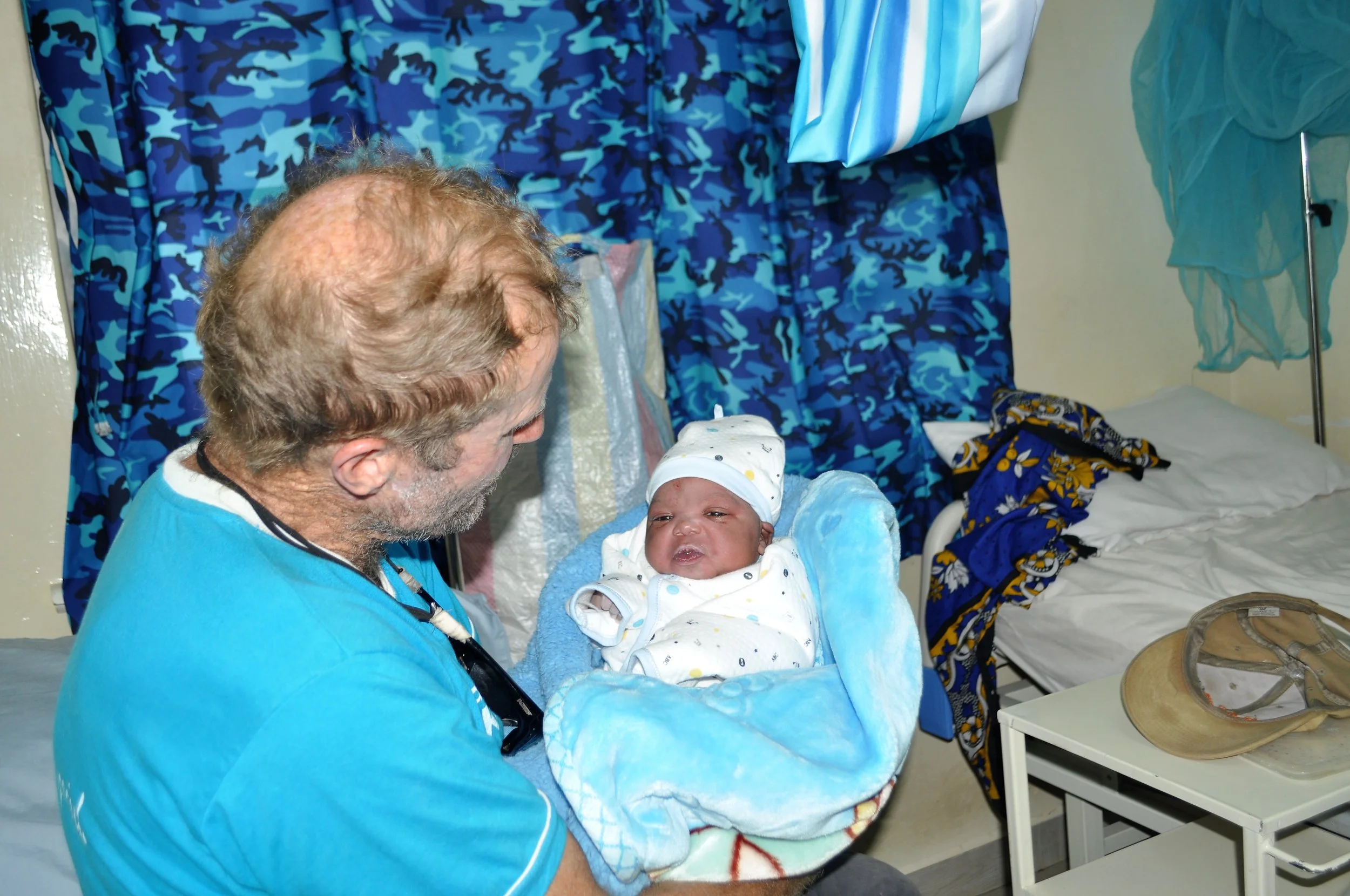Br. Frank welcoming our Christmas baby- Baby Emmanuel