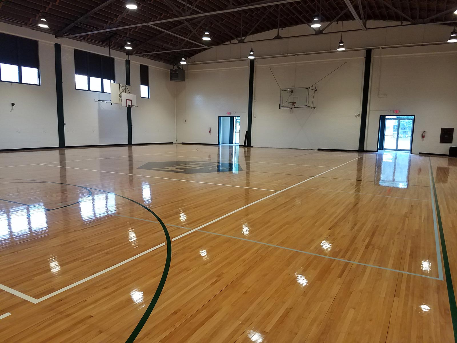 The restored original floor of the gymnasium at the historic high school campus in Taylor. The 1930s gymnasium now serves as an event center with new restroom, bar and kitchen facilities. The campus required a Planned Development for reduced parking minimums, additional permitted uses and amplified sound, and the gymnasium required a building permit for the new restrooms, demo of interior walls, life safety features and commercial kitchen. We wrote the Planned Development documents, negotiated with city staff and presented the Planned Development to Taylor City Council for approval, which was unanimous.