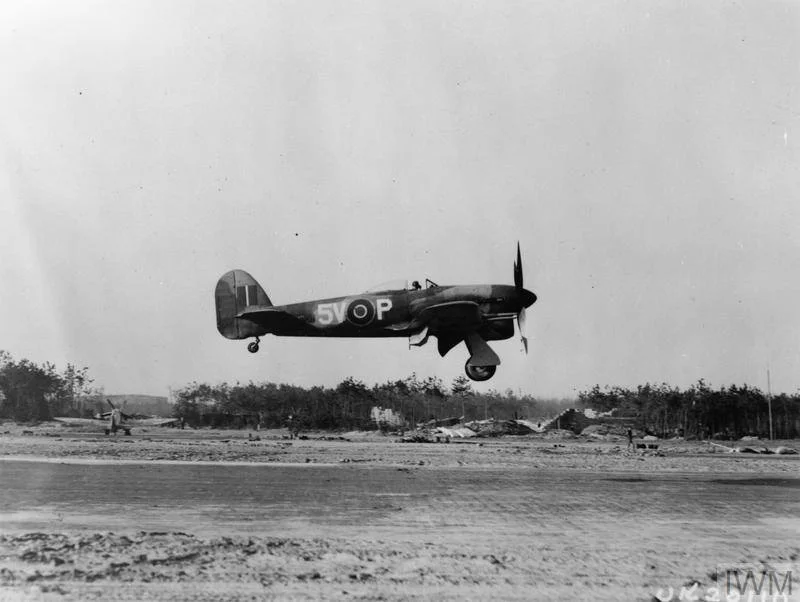 A Hawker Typhoon fighter-bomber of 439 Squadron RCAF returns from a mission over enemy lines. © IWM (MH 6864)