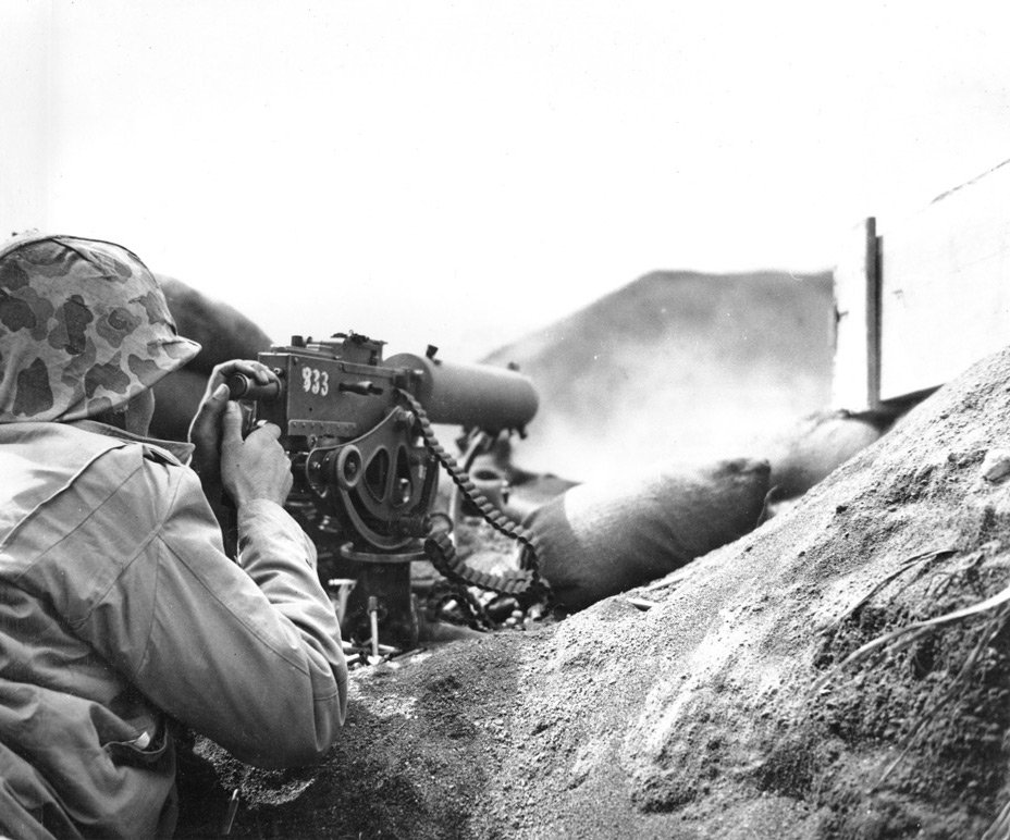 A U.S. Marine firing his Browning M1917 machine gun at the Japanese