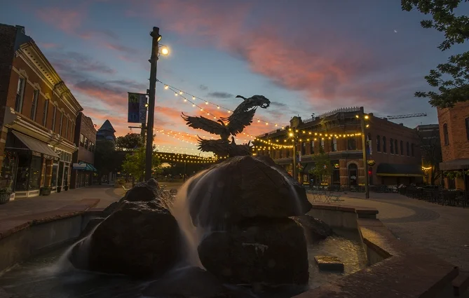 The sun sets over old town square in fort collins