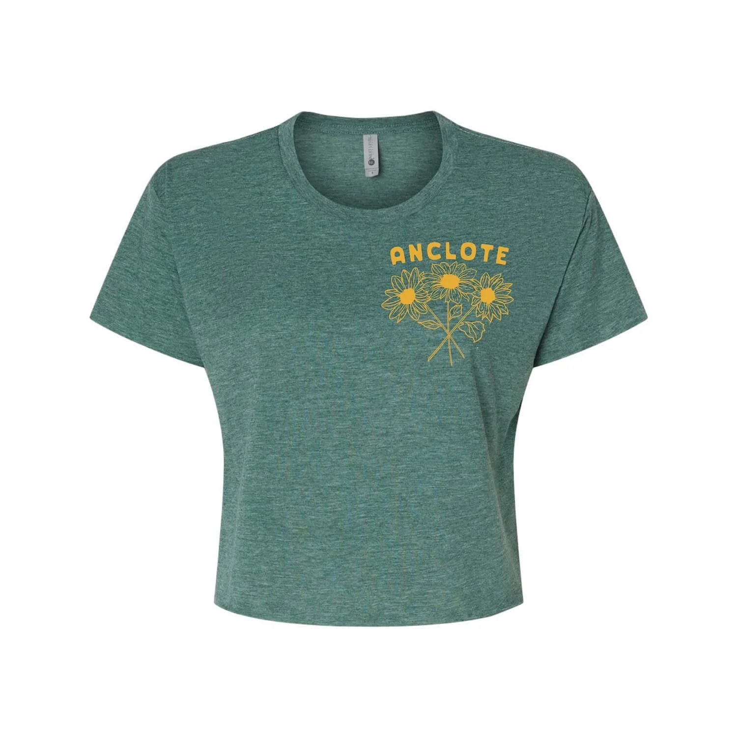 Front of a heather green crop shirt featuring a left chest of a hand drawn screen printed graphic of beach sunflowers native to Florida with the word "Anclote"