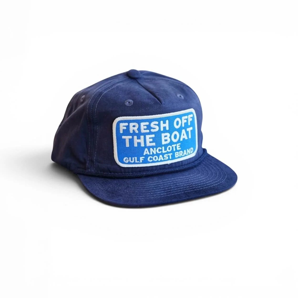 Navy blue cotton rope snapback hat with ‘Fresh Off The Boat’ blue embroidered patch, flat brim, studio product photo.