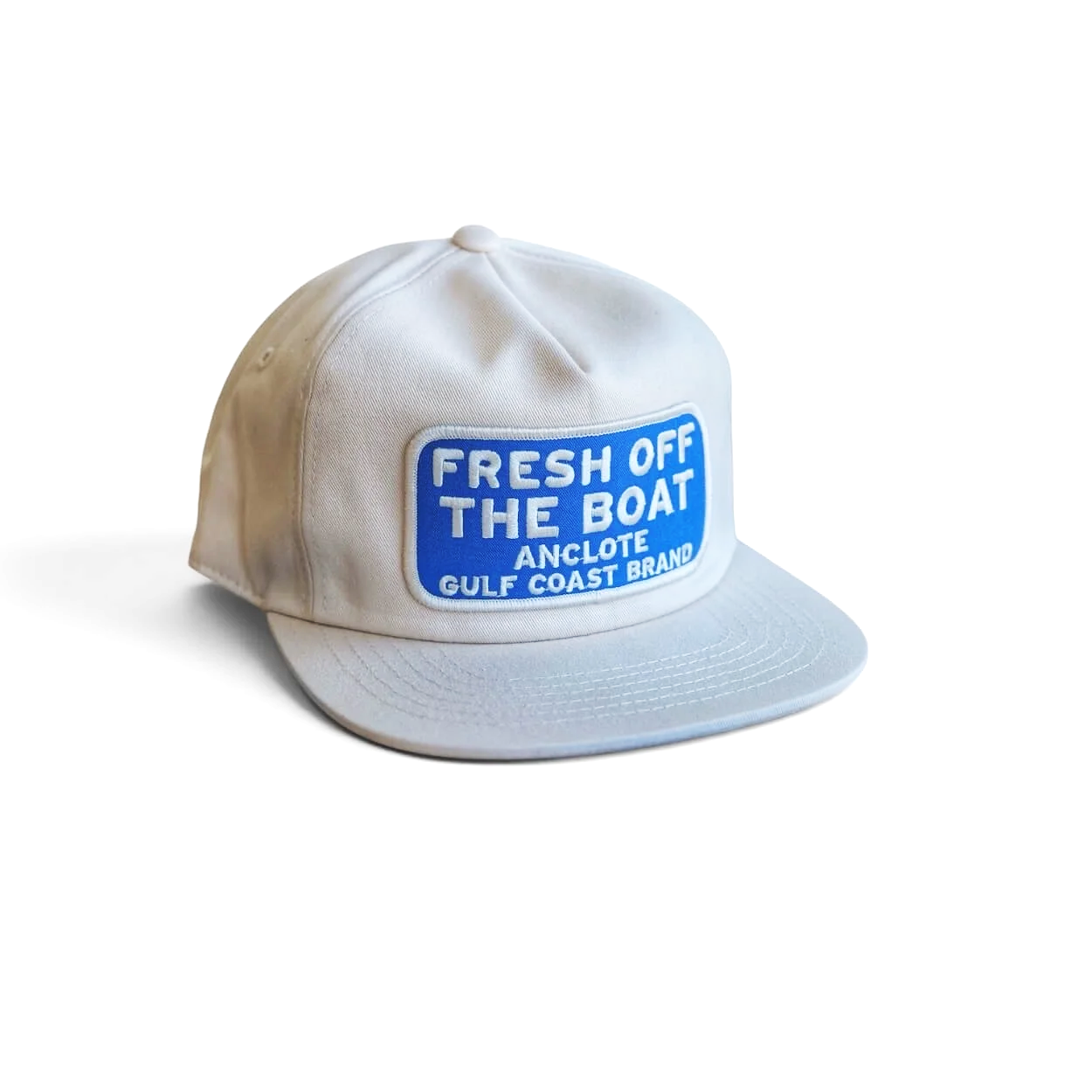 Eggshell-colored Fresh off the Boat snapback cotton hat with blue embroidered patch on a clean white background.