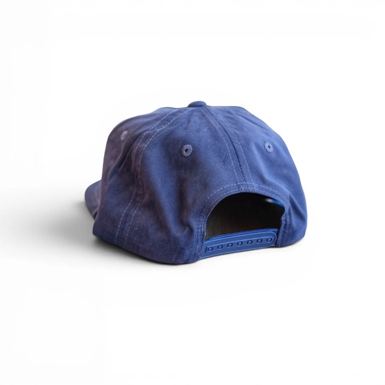 Back of Navy blue cotton rope snapback hat with ‘Fresh Off The Boat’ blue embroidered patch, flat brim, studio product photo.