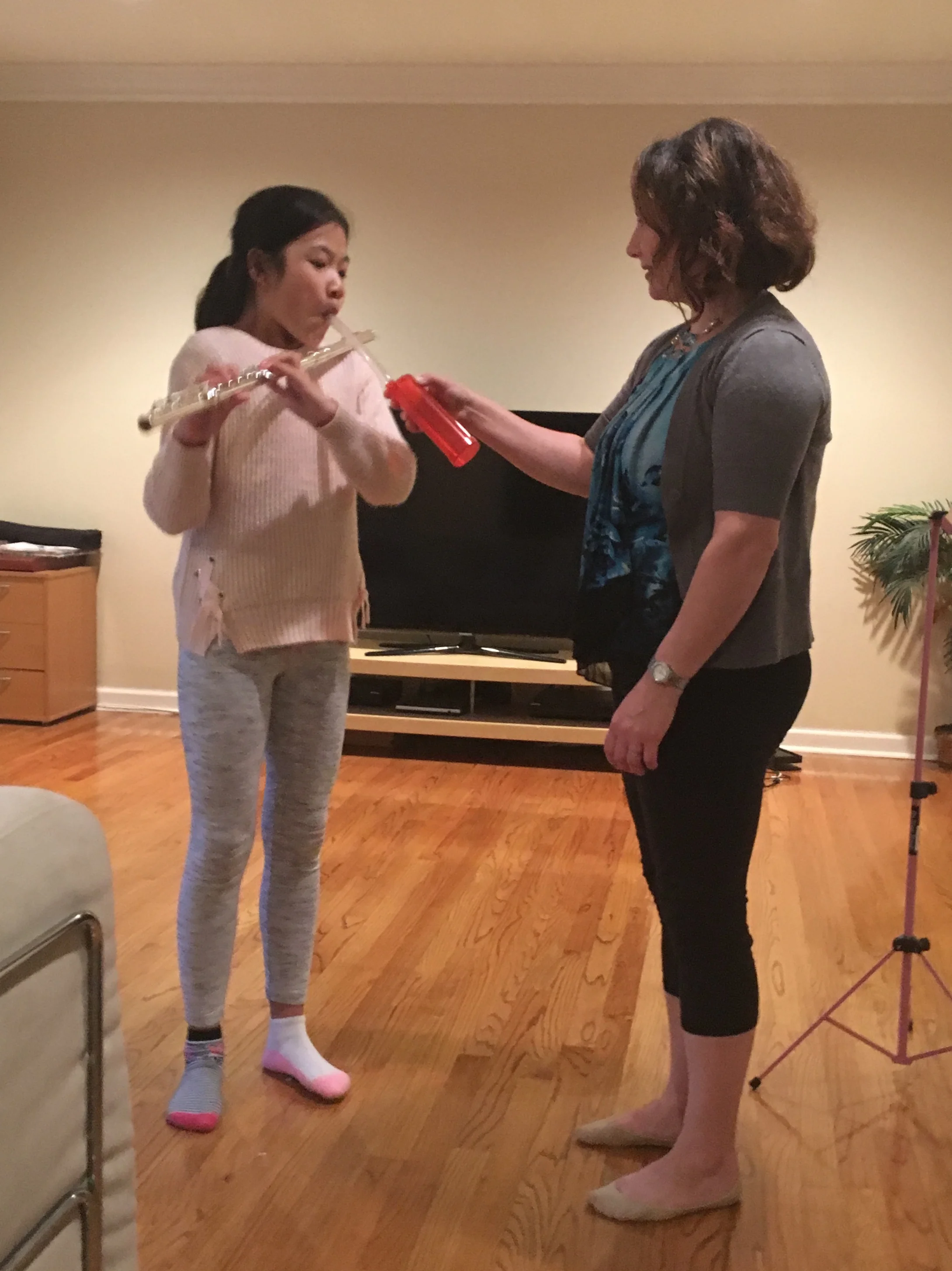 Flute student using a breath builder to improve her breathing ability and tone
