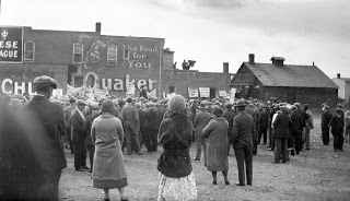 Crowd listens to a speaker at a Communist Party rally in Lethbridge. The Chinese National League building is in the background 1935 to 1940 in Red Square Courtesy the Galt Museum & Archives: 20011020734