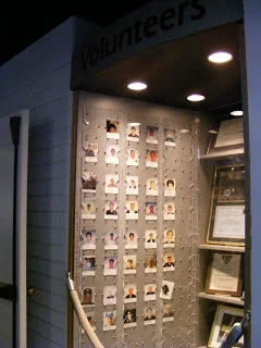 A volunteer display at the Hill Aerospace Museum - it was in a hallway in the main area that you had to walk through to get to the display. It told not only the volunteer's name, but what year they started volunteering with the museum, plus, as you can somewhat see, photos of volunteer events, awards won by volunteers, etc.