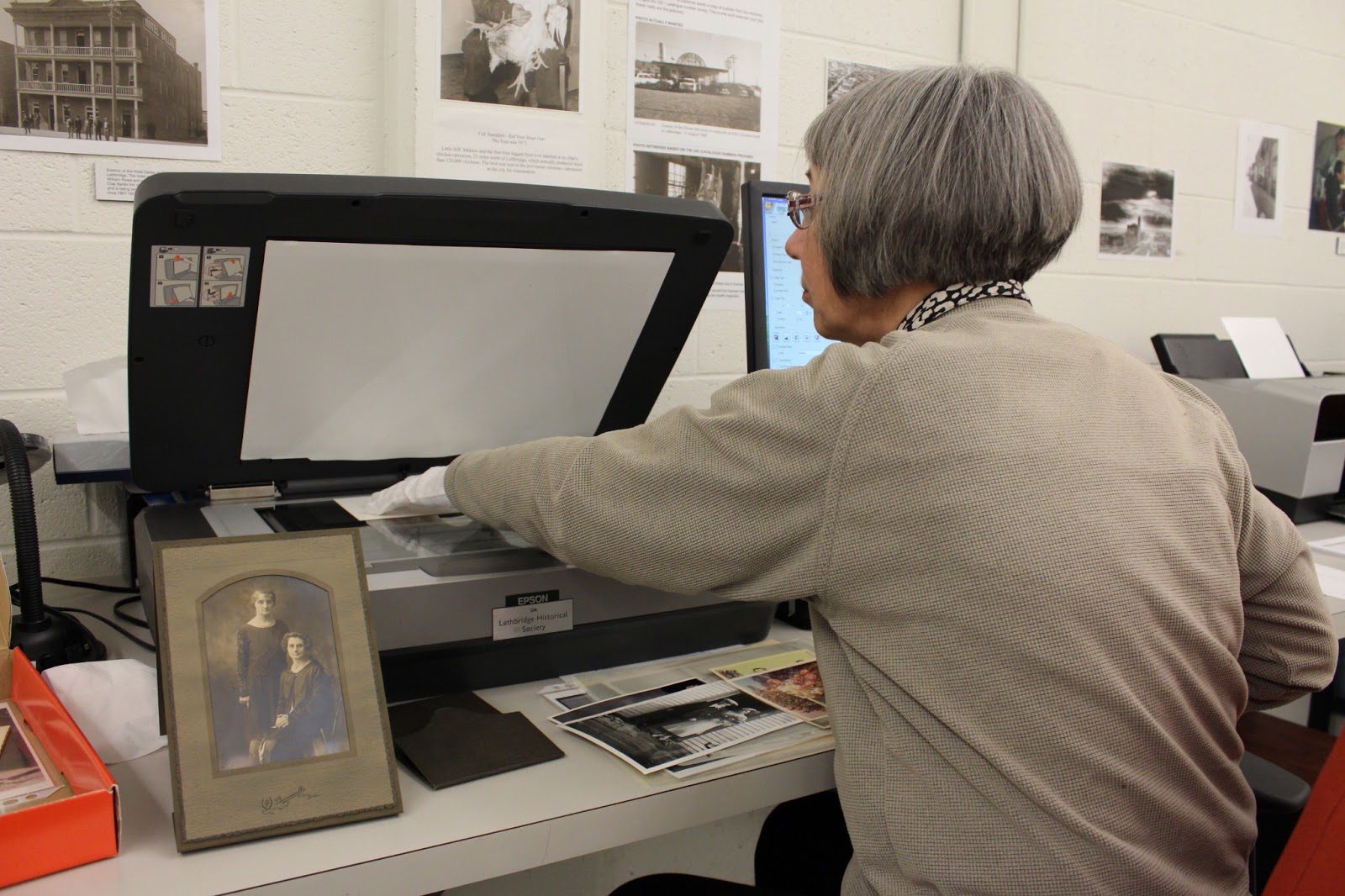 Volunteer Alice scans photos at the Archives!