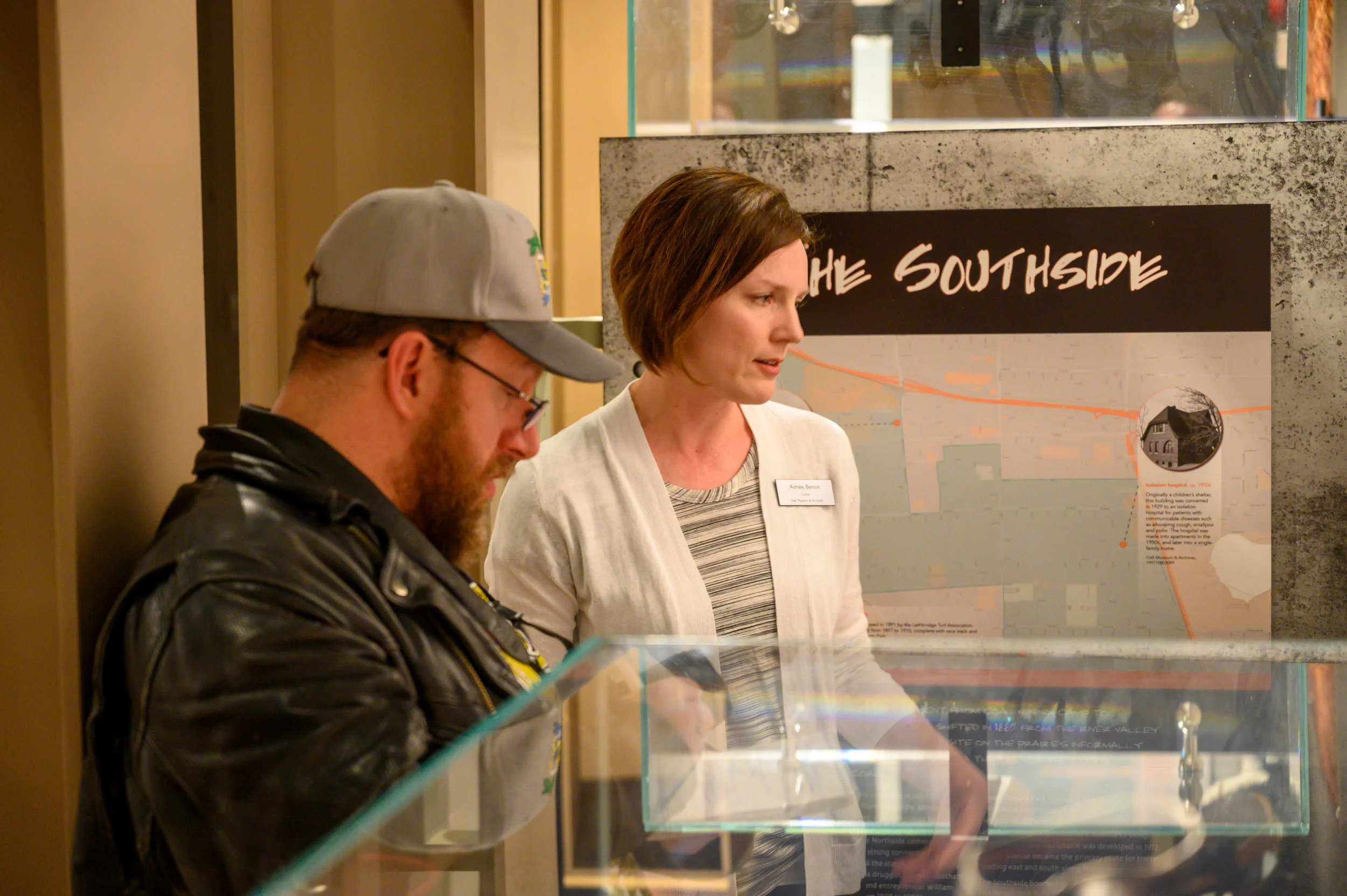 Curator Aimee Benoit shows Richard Amery, Editor of LA Beat, the Southside portion of the exhibit.