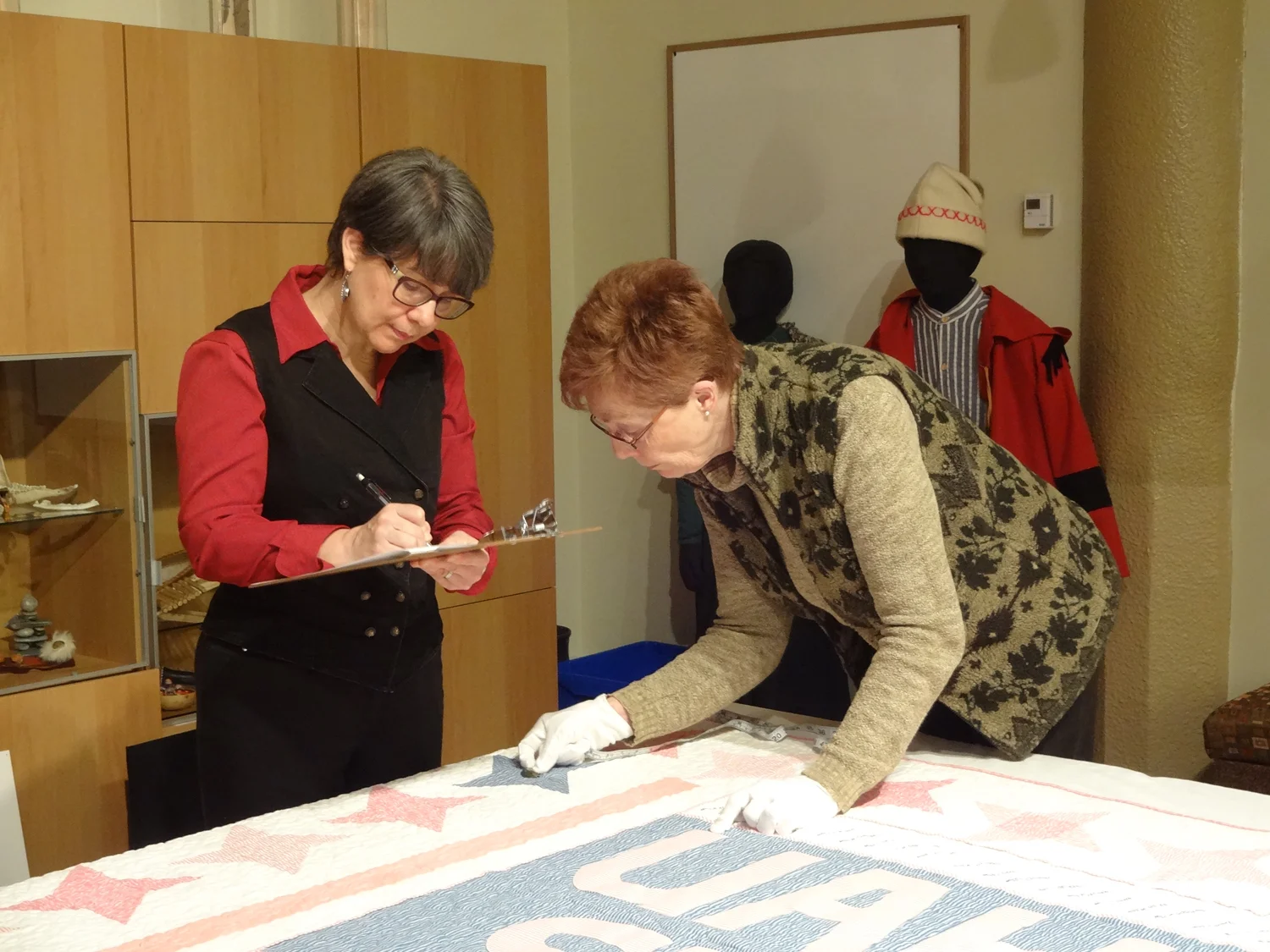 Lucie Heins (left) and volunteer Diane Bretton at the Musée Héritage Museum in St. Albert at a recent documentation event. Photo by Shari Strachan.