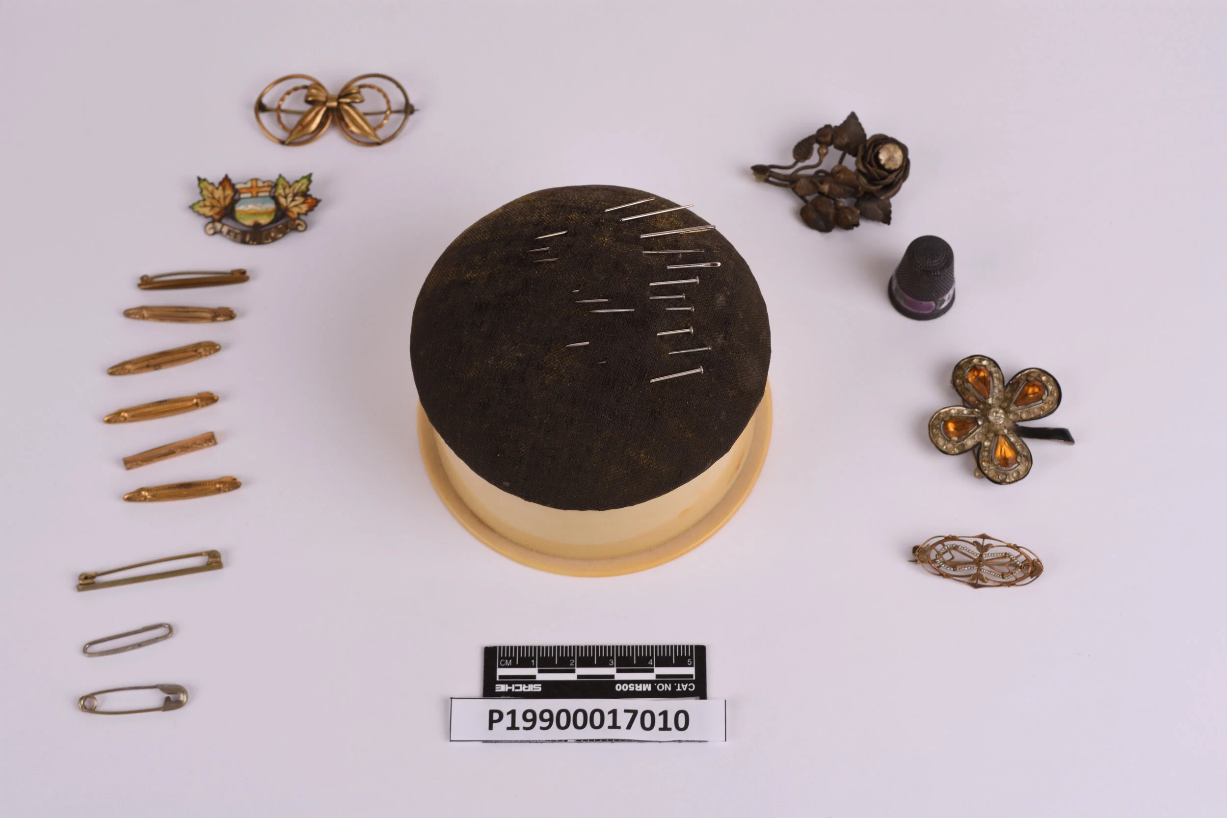 A pin cushion and pins and clasps donated to the Galt by Laurie Davis. Photo courtesy the Galt Museum & Archives: 19900017010