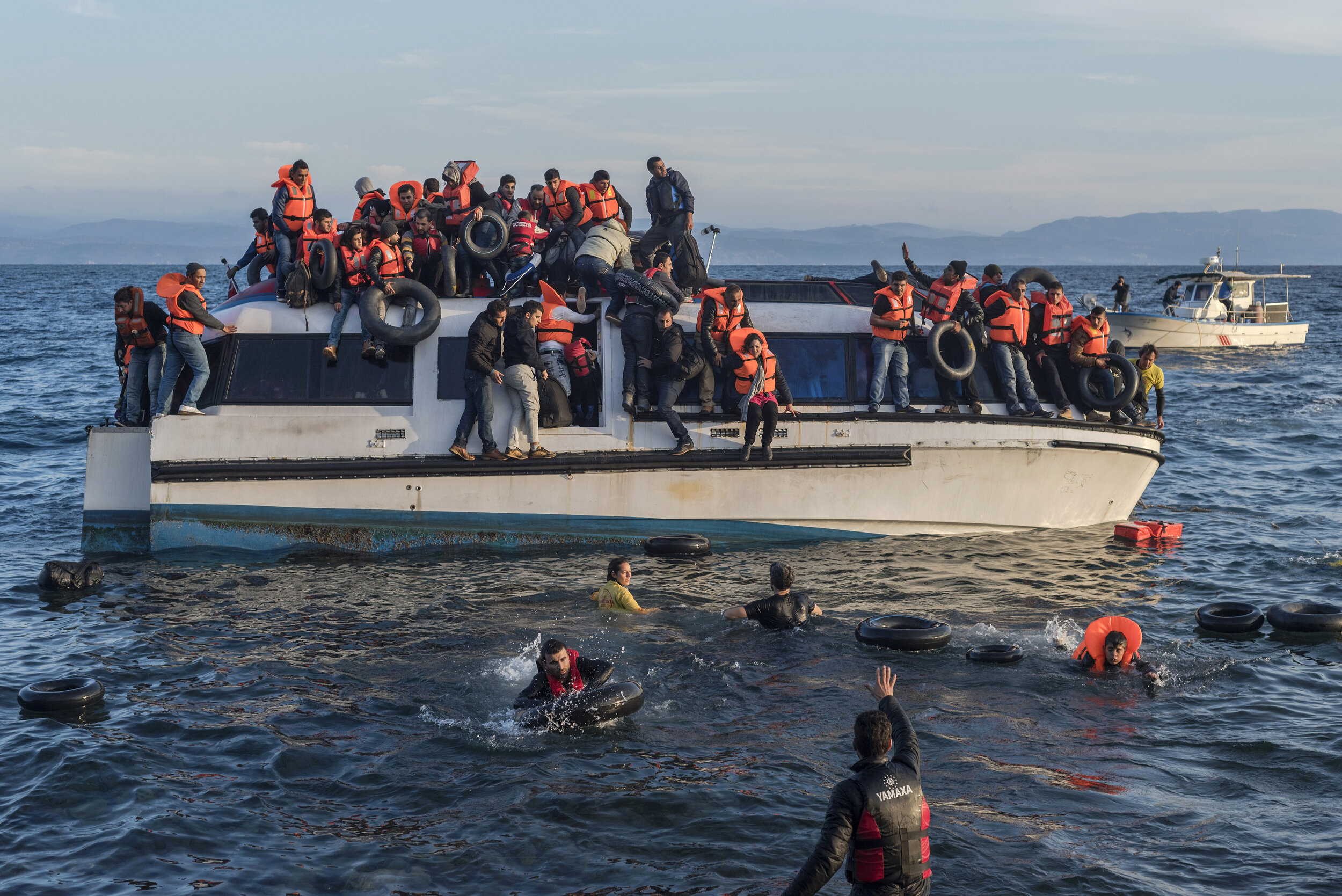 Iraqi and Syrian refugees in a sinking boat arriving from Turkey to Lesbos island, Greece, October 30,
