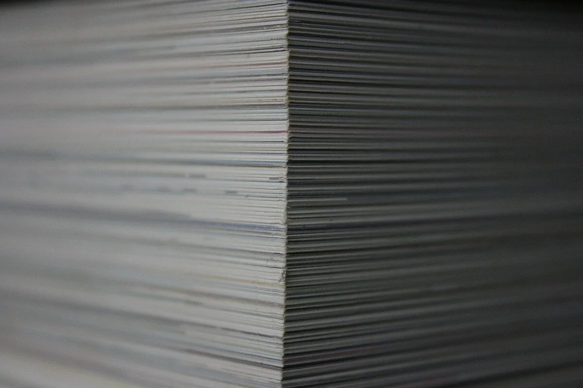 Close-up of a large stack of documents representing financial records and planning for Stimulus Check 2025.