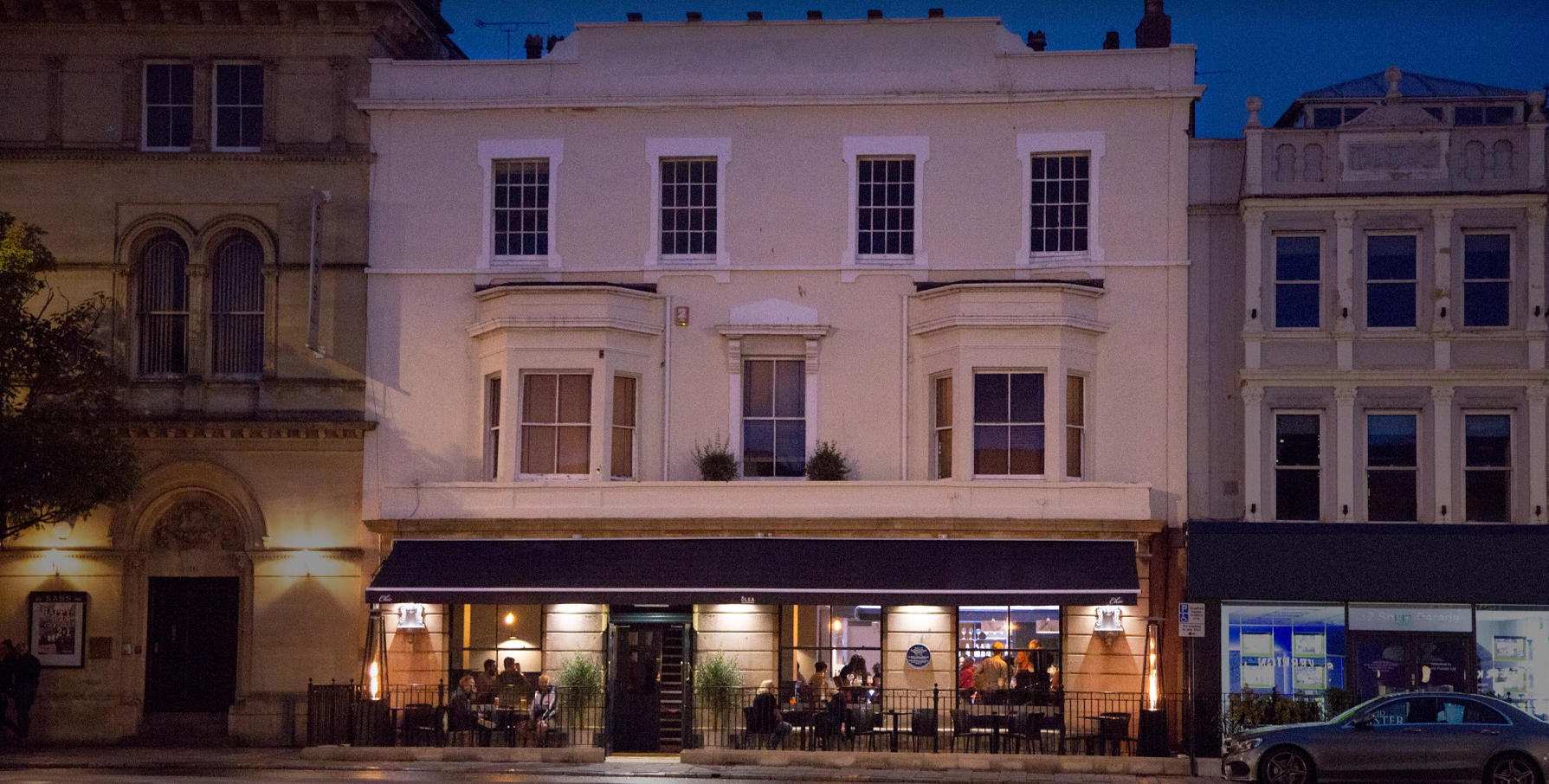 Olea Lounge exterior on South Parade, Weston-super-Mare, lit up at dusk