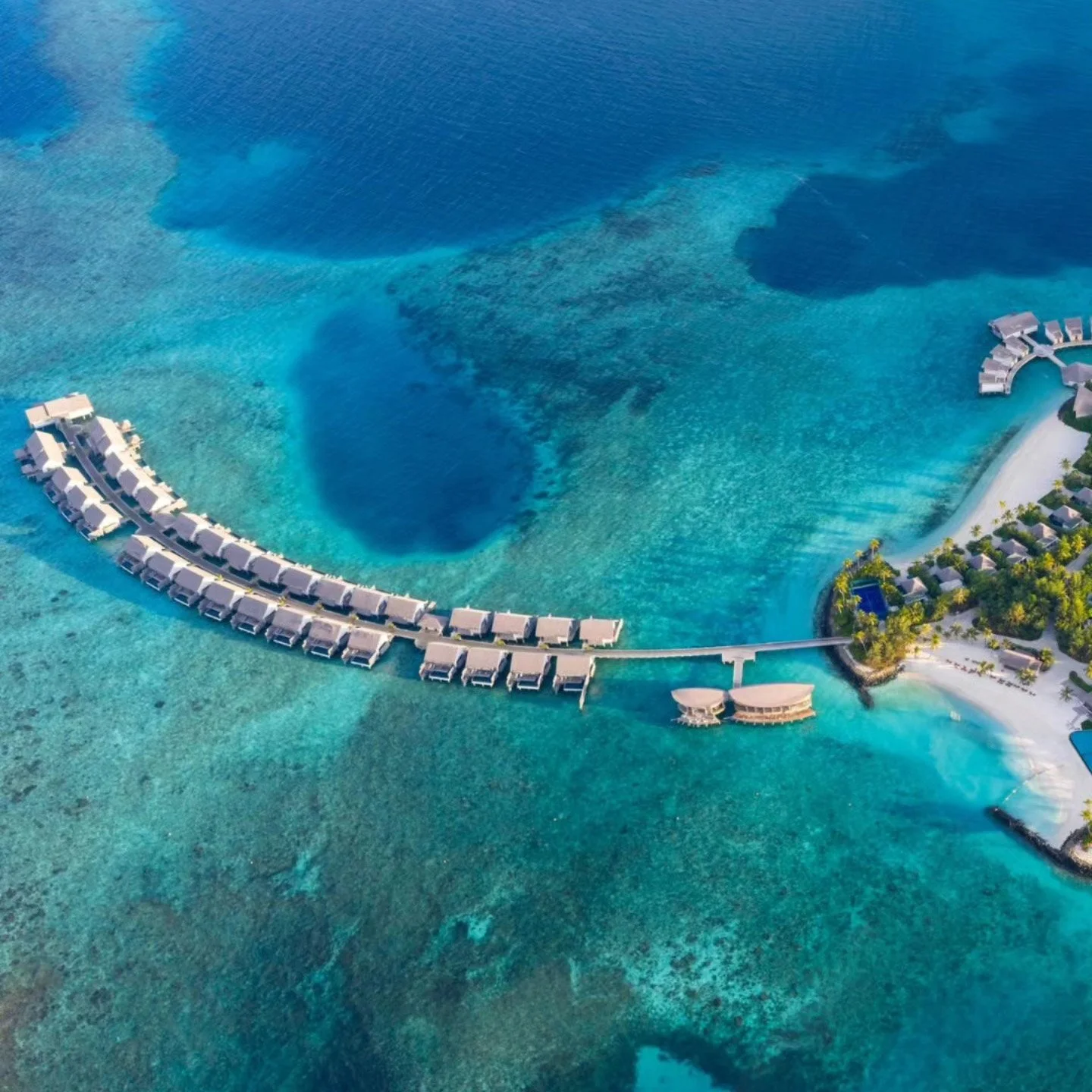 "From above, Hilton Maldives Amingiri Resort &amp; Spa reveals its breathtaking beauty &mdash; turquoise lagoons, overwater villas and powder-soft beaches surrounded by endless Indian Ocean blues, where every moment feels suspended between sky a