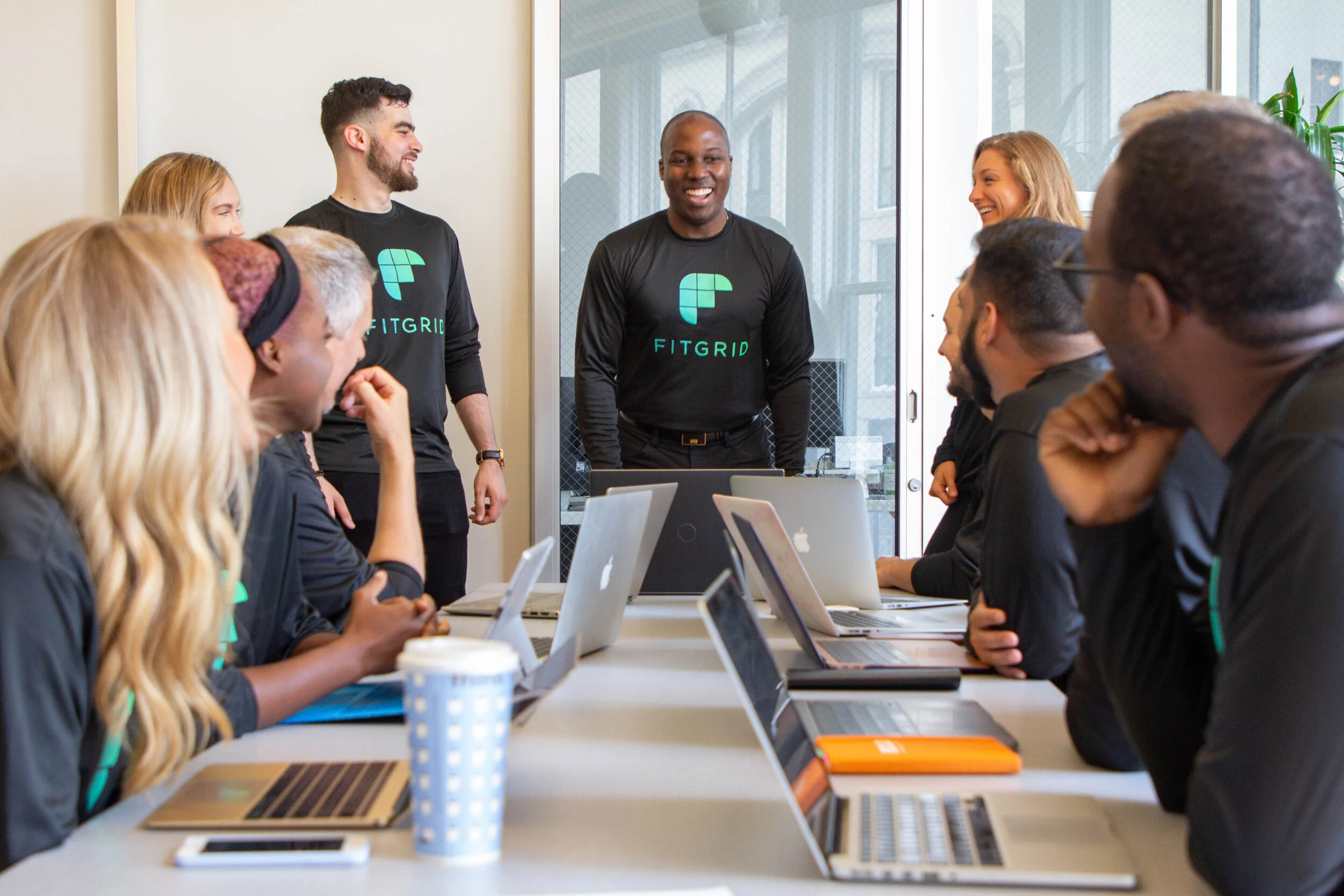 nt surrounded by team and laptops.jpg