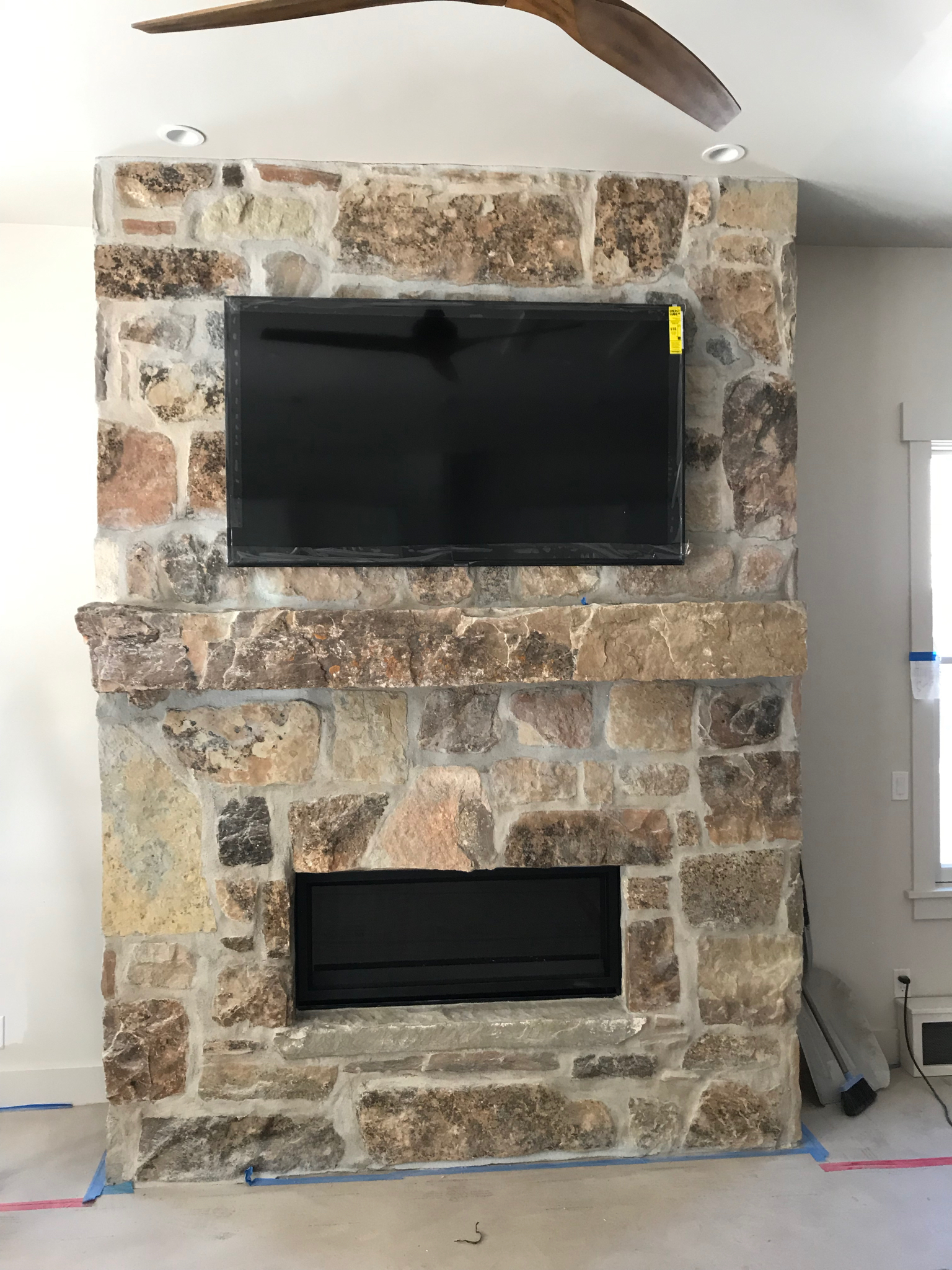  TV installed with a motorized TV mount at a residential space in Park City, Utah. This is the mount at its start position… 