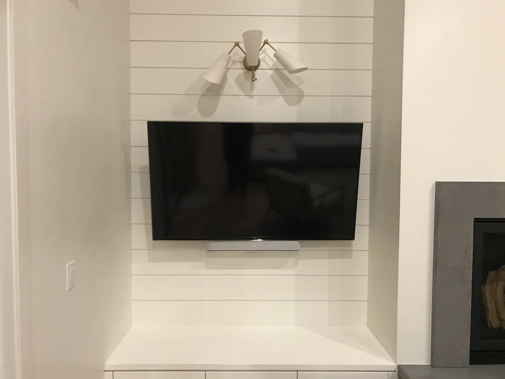  TV mounted and paired with a Sonos sound bar. 