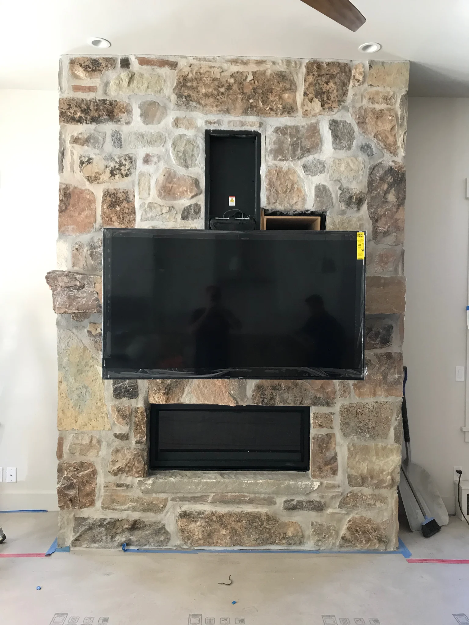  … And this the TV in a full-down position. The motorized TV mount allows the user to move the TV with a remote. This client wanted the TV mounted above the fireplace, but the mantle was positioned at a height that was uncomfortable for viewers to lo