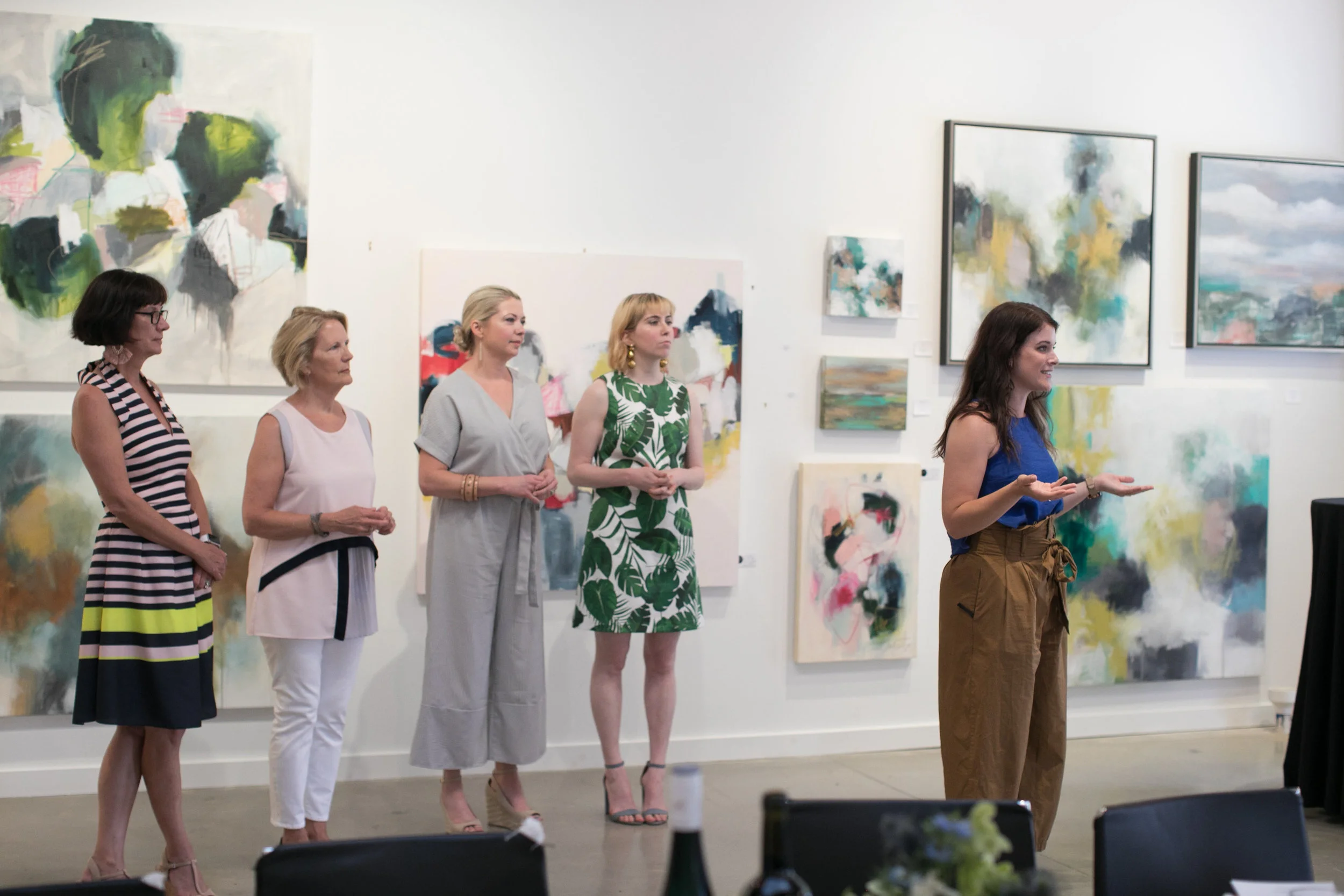 Art Farm Director Megan Schaeffer introduces artists Lulie Wallace and Raven Roxanne to Art Over Dinner guests at Grange Hall.