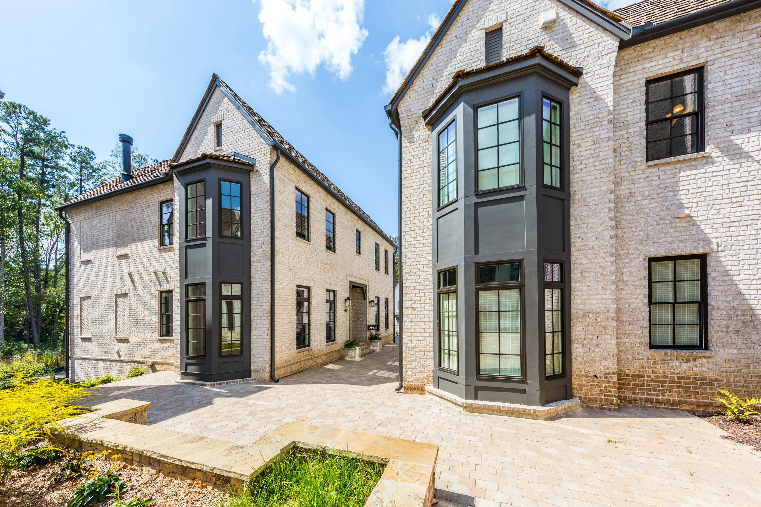 Walk the cobblestone streets through the Manor Homes archway to see the Anders Walk cottages, which overlook the Mado woods. Photo by Richie Gill Photography.