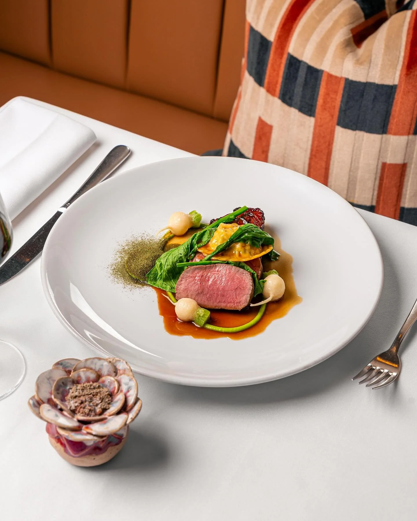 Roast loin of Cumbrian lamb, braised neck, buttered turnips, pea and mint ravioli, vermouth jus