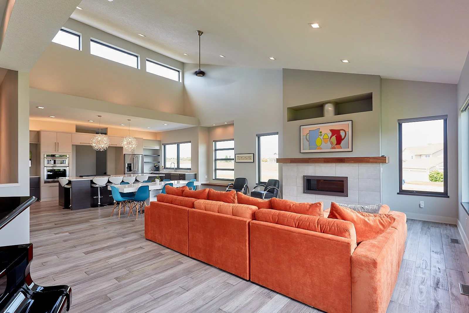 Modern kitchen and impressive television which displays any variety of art.