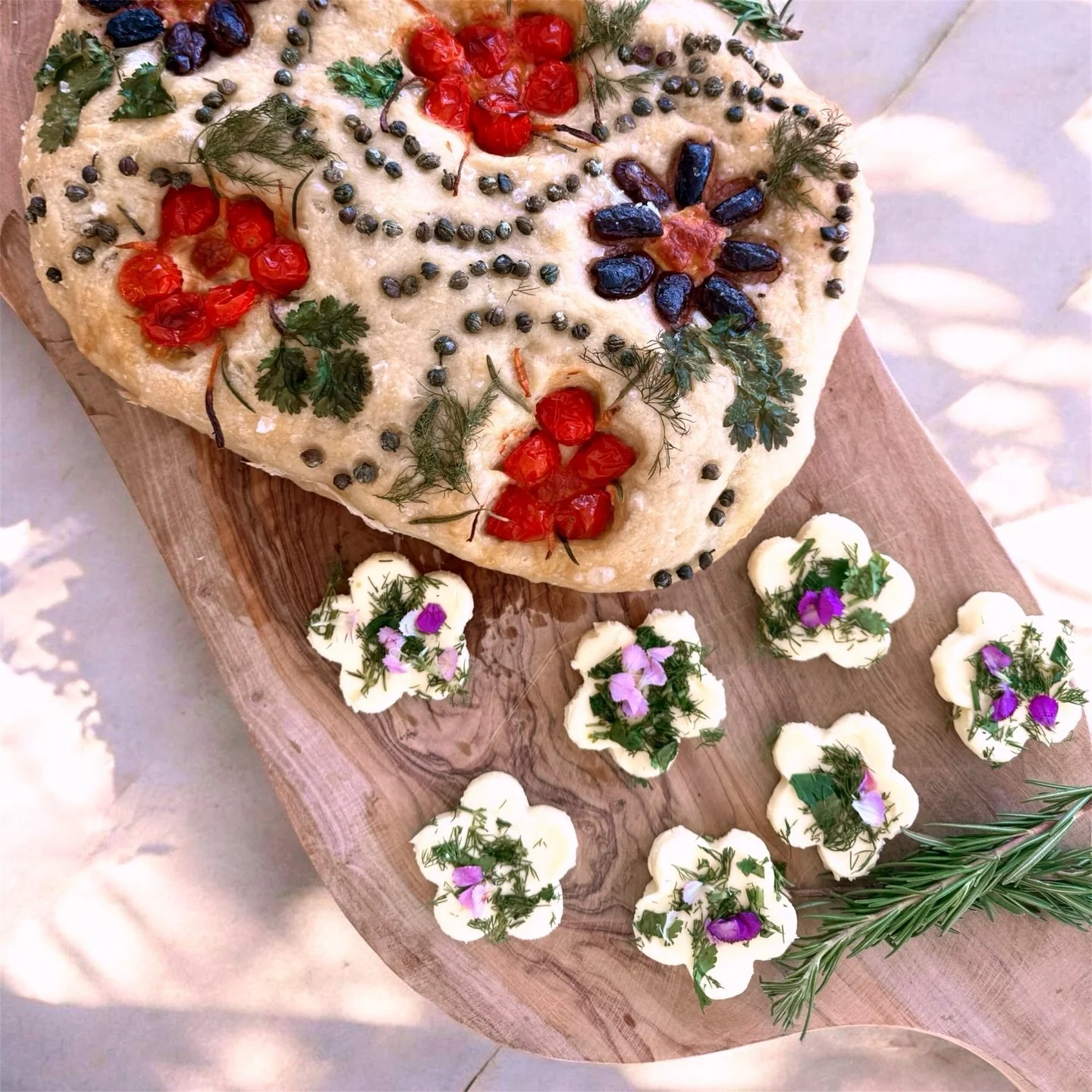 There&rsquo;s something about baking focaccia that feels a little like painting.

This one is topped with sweet tomatoes, herbs, olives and capers &mdash; and served with homemade whipped butter shaped like little flowers, finished with fresh herbs a