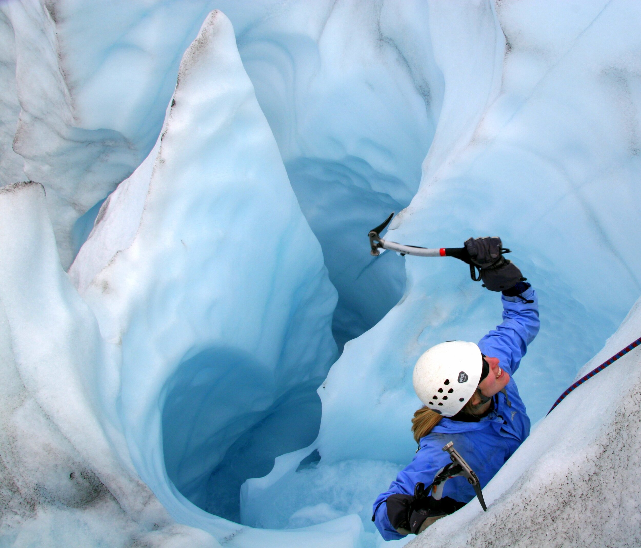 Daytrip Glacial Adventure: Girl summiting ice climbing wall