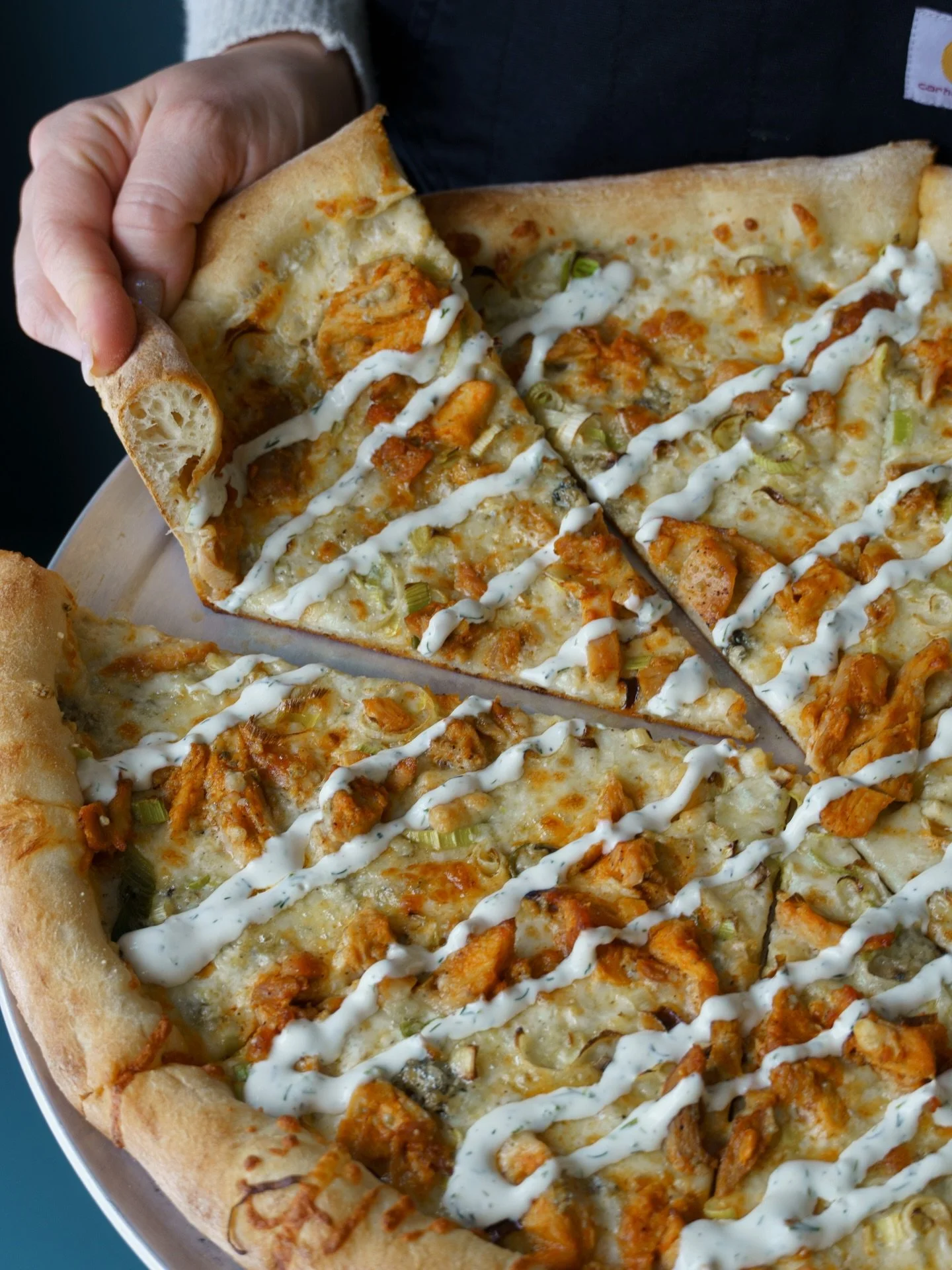 Meet The Grazer. A mainstay on our menu and one of our most popular pies!

Built on a white sauce base and topped with buffalo chicken, blue cheese, shaved leeks, and finished with a creamy dill dressing. If you&rsquo;re a blue cheese lover, this one