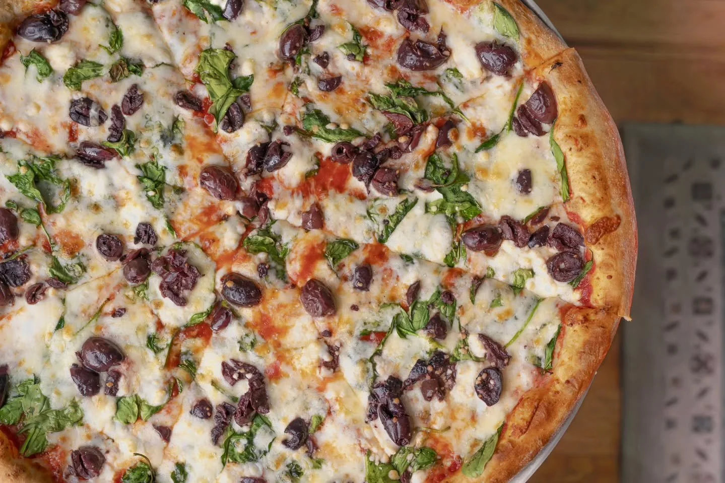 Meet the Homesteader🍋🌿 
A hearty red pie layered with Romano, garden spinach, melty mozzarella, Kalamata olives, creamy feta, and preserved lemon. 
It all comes together for a pie that's bold, briny, and beautifully balanced. 😌