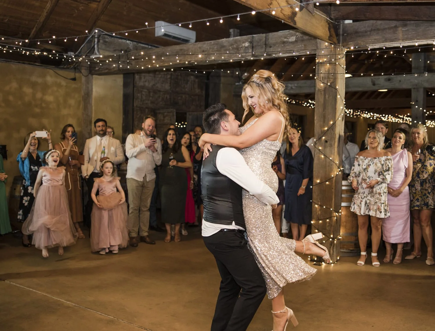 groom picking up bride during bridal dance at Peppers Creek Barrel Room  
