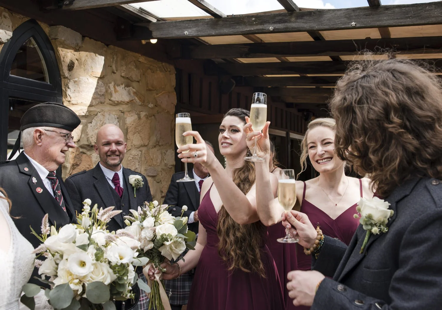 bridal party cheering at the front of Peppers Creek Barrel Room  