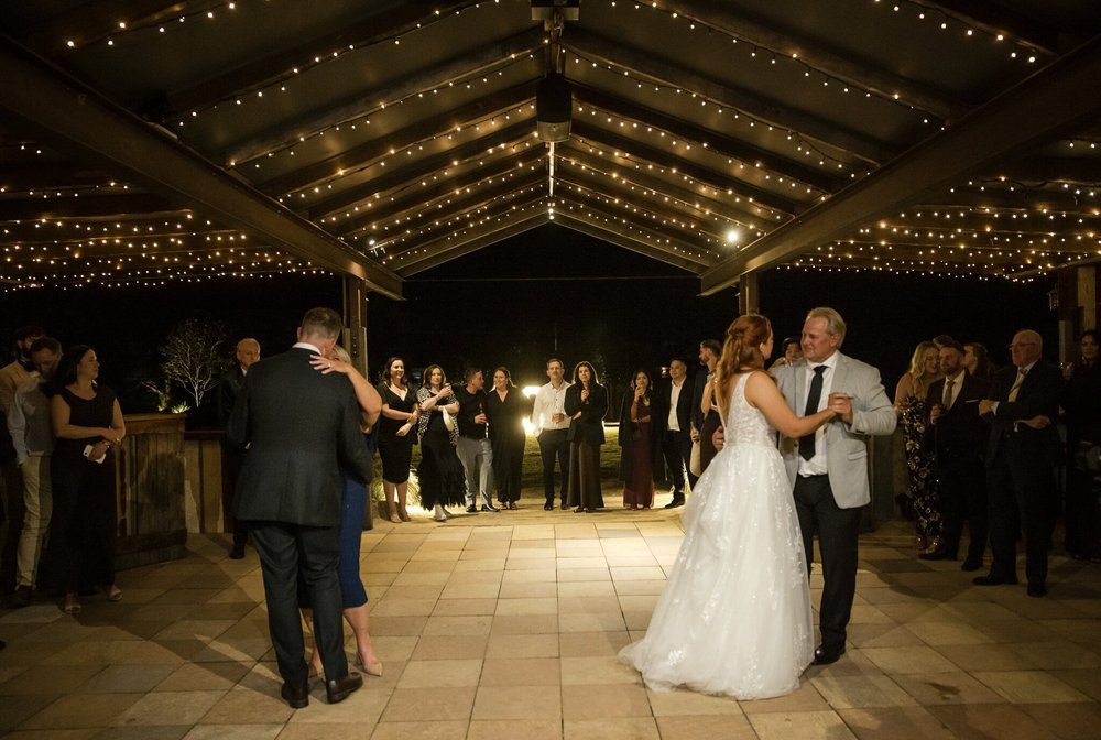 Parent dances under the fairy lights in the pavilion, Adams Peak Country Estate, Broke