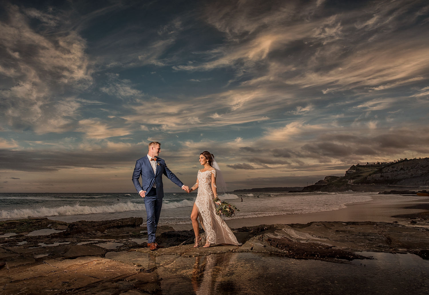 Newcastle beach wedding photographer  designer dress in the sunset 