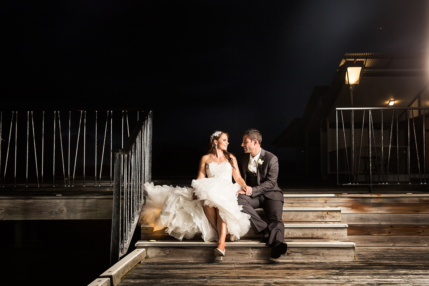 caves beach wedding bride and groom under the lights on boardwalk