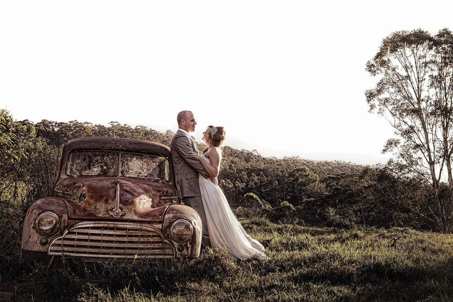 Hunter Valley couple beside a rustic vintage car