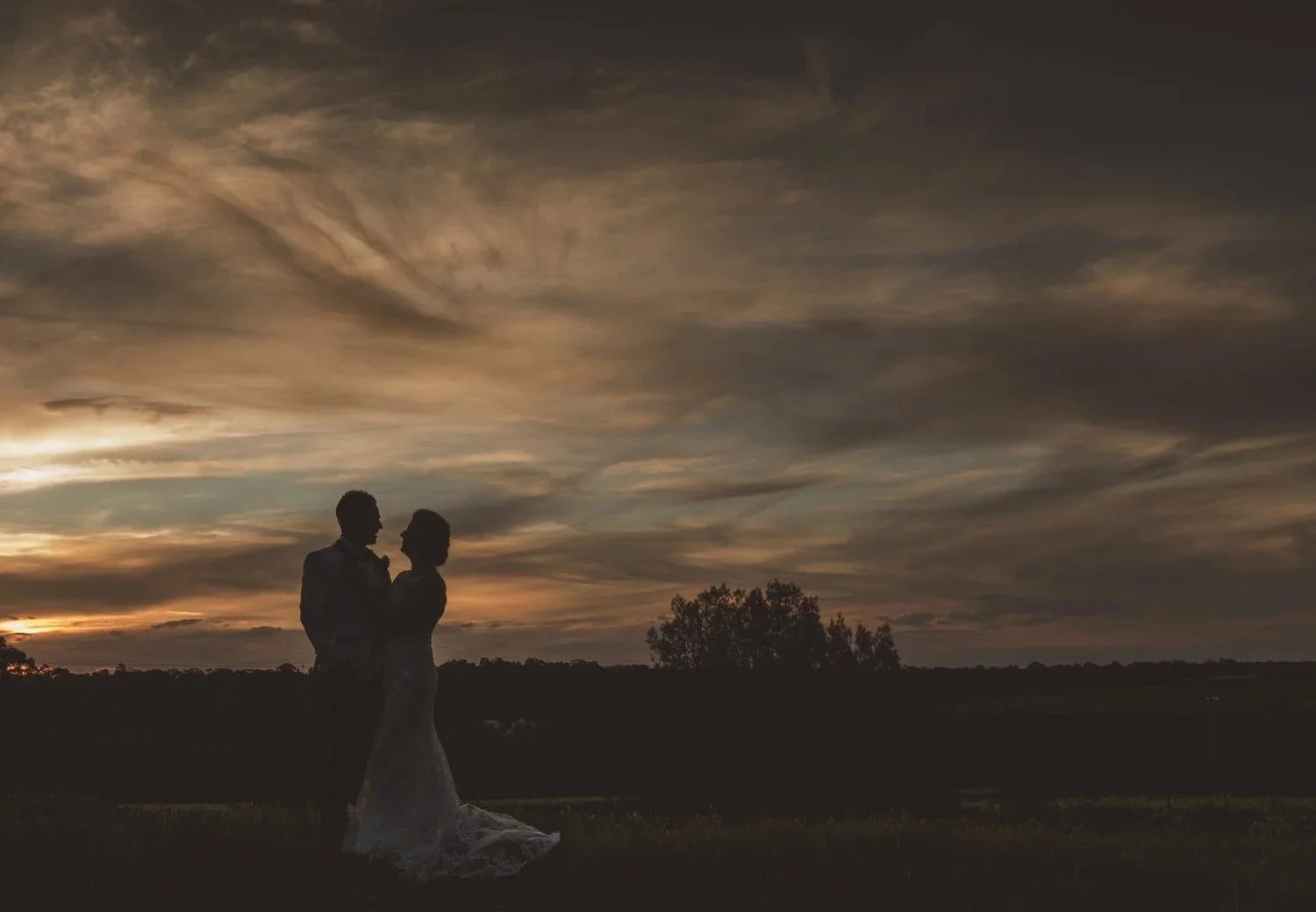 Couple silhouetted against a moody sunset sky, Spicers Vineyards Estate, Pokolbin
