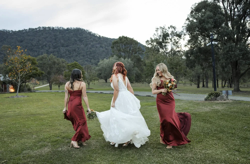 Bride and bridesmaids twirling on the lawn in the late afternoon, Adams Peak Country Estate, Broke