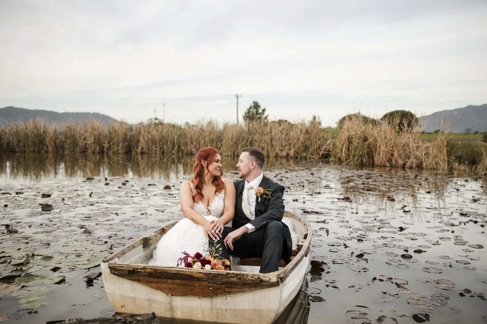 Couple sitting in a rowboat among the lily pads on the pond, Adams Peak Country Estate, Broke
