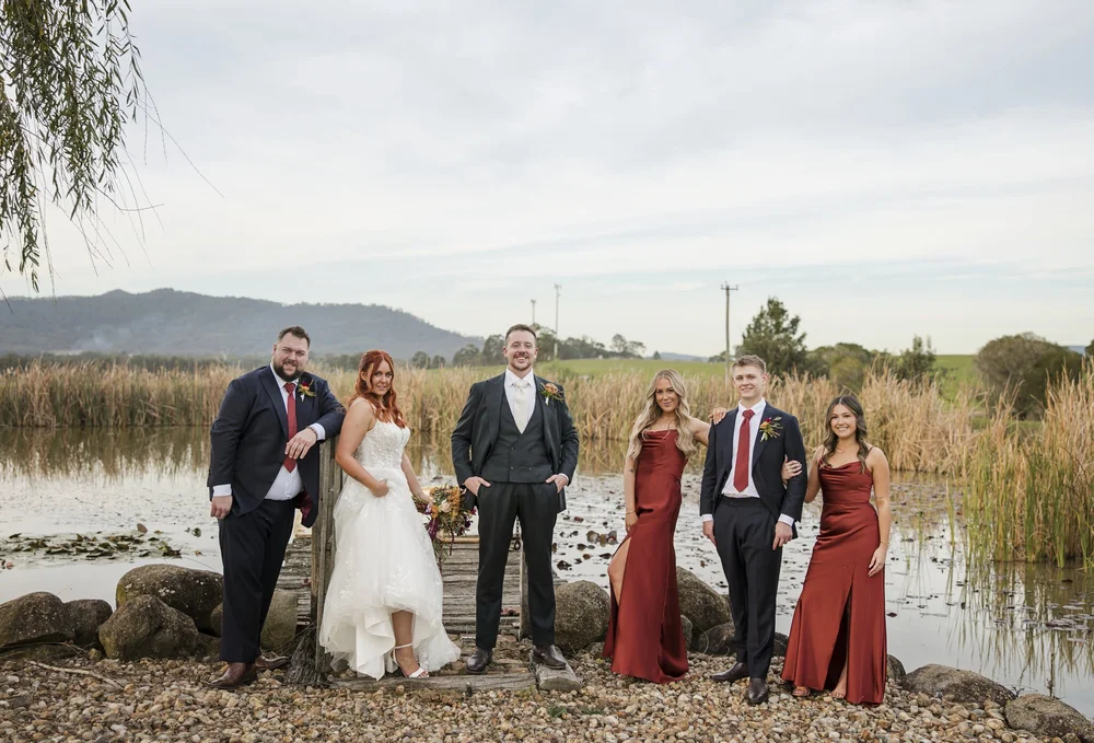 Bridal party by the pond and reeds with the hills behind, Adams Peak Country Estate, Broke