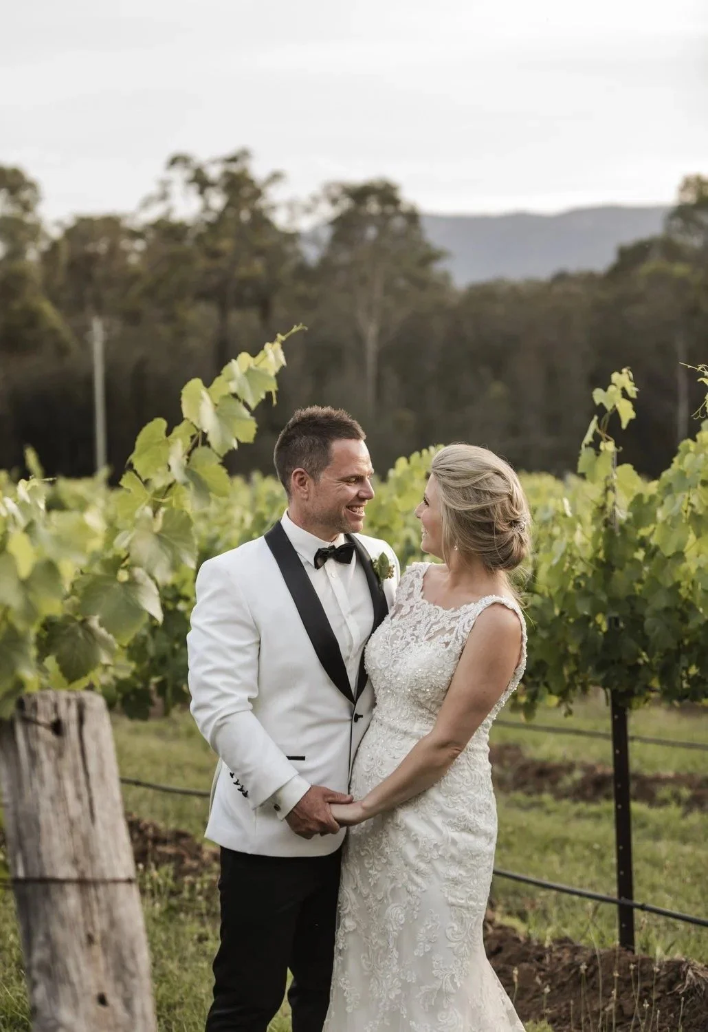 Couple among the vines at golden hour, Spicers Vineyards Estate, Pokolbin