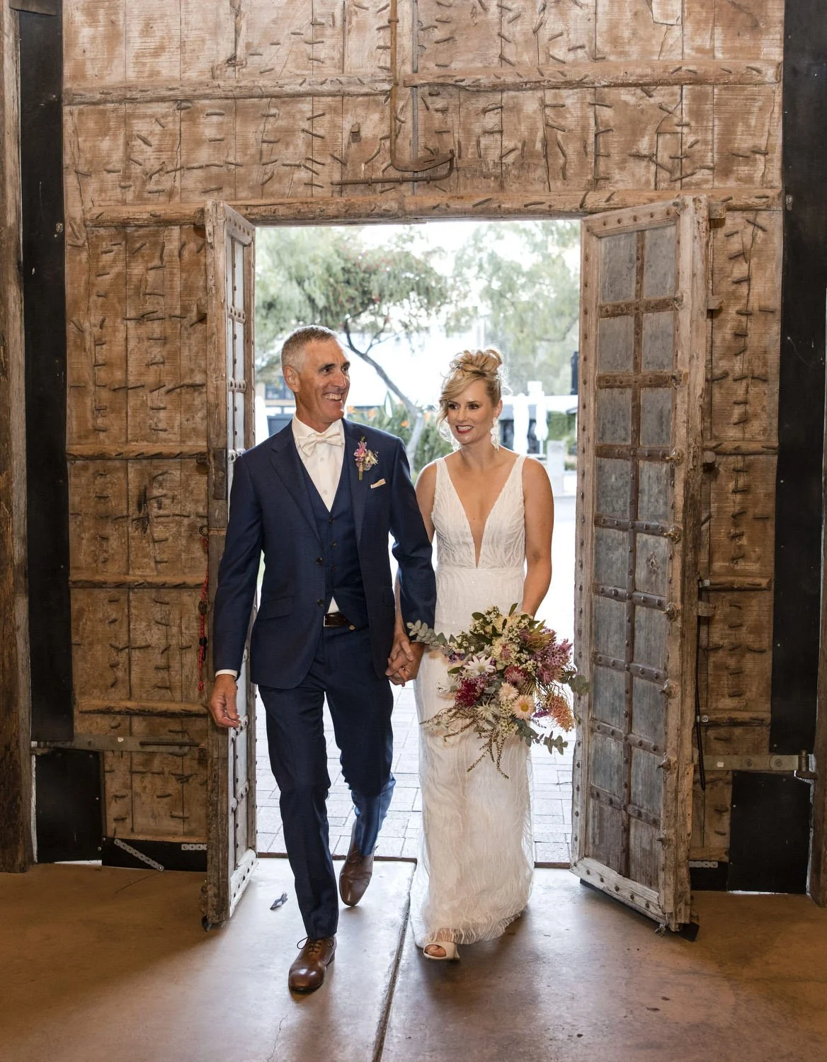Bride and Groom walking in to Peppers Creek Barrel Room  